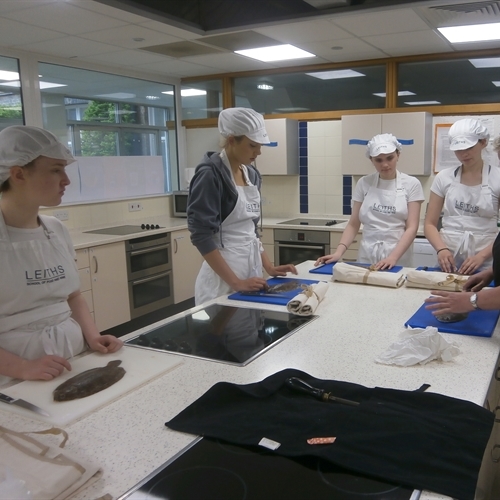Year 12 students learn to fillet flat fish in Leiths workshop